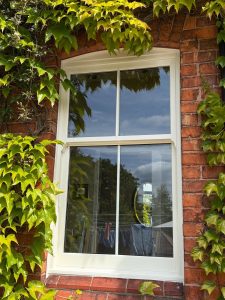 A white, sliding sash window